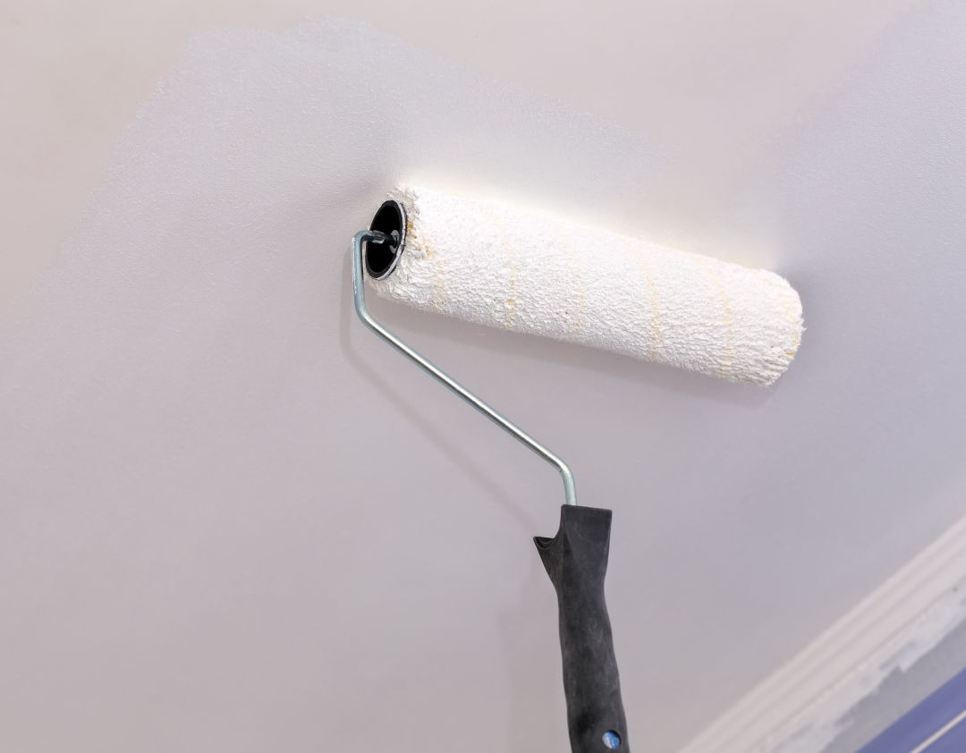 Painting a ceiling with a paint roller
